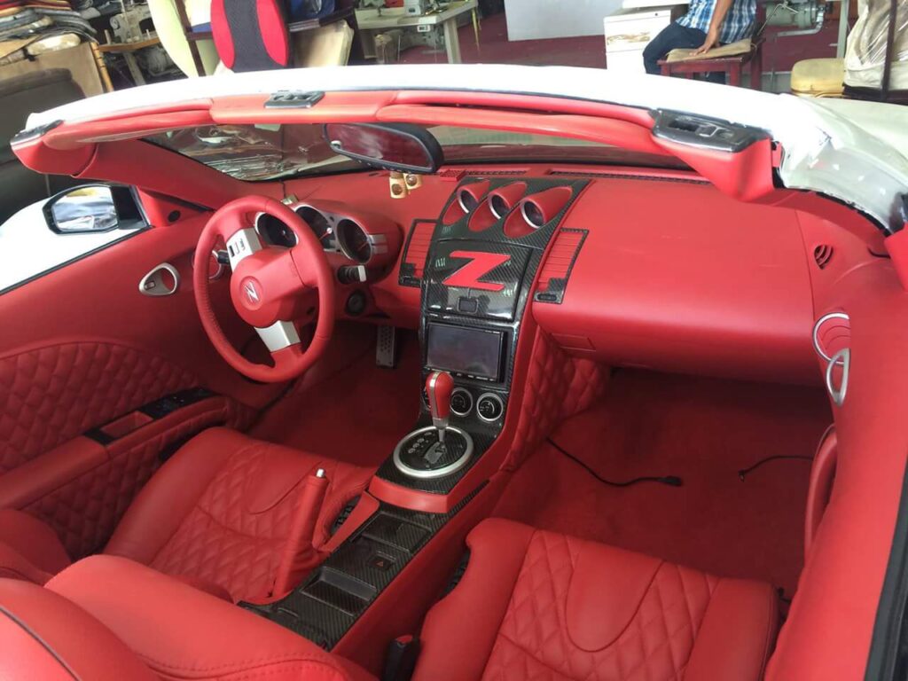 Interior view of a red sports car featuring luxurious leather seats and premium car upholstery, showcasing elegance and style.