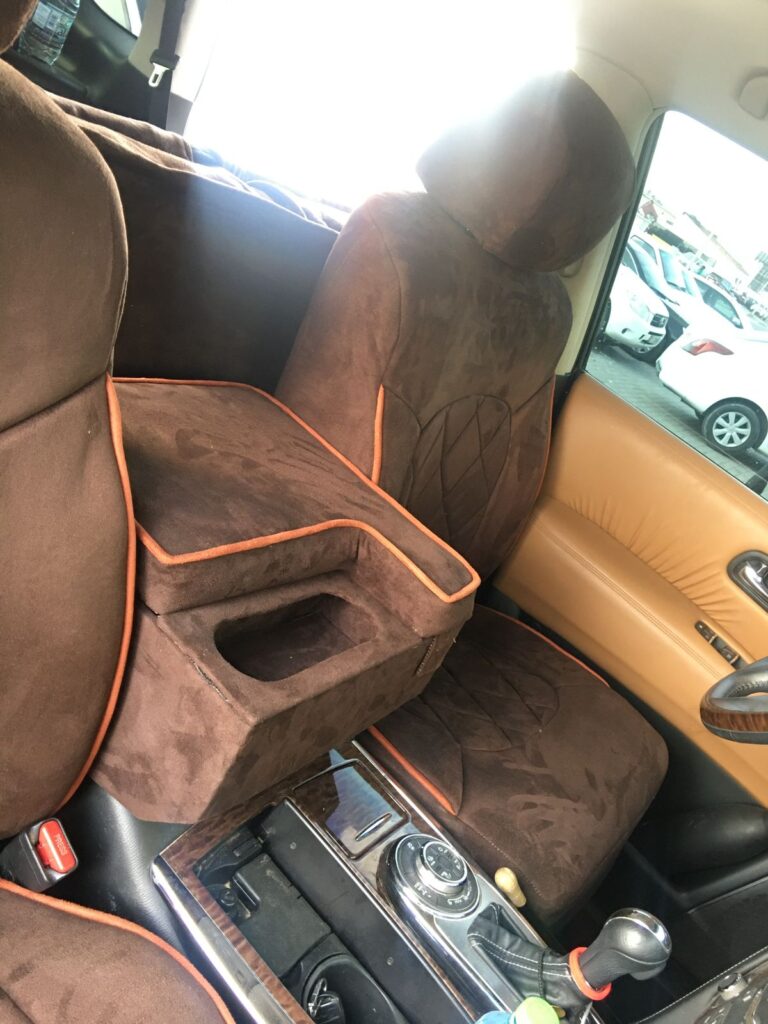 Interior view of a car featuring stylish brown and orange seats, showcasing a modern and vibrant design.