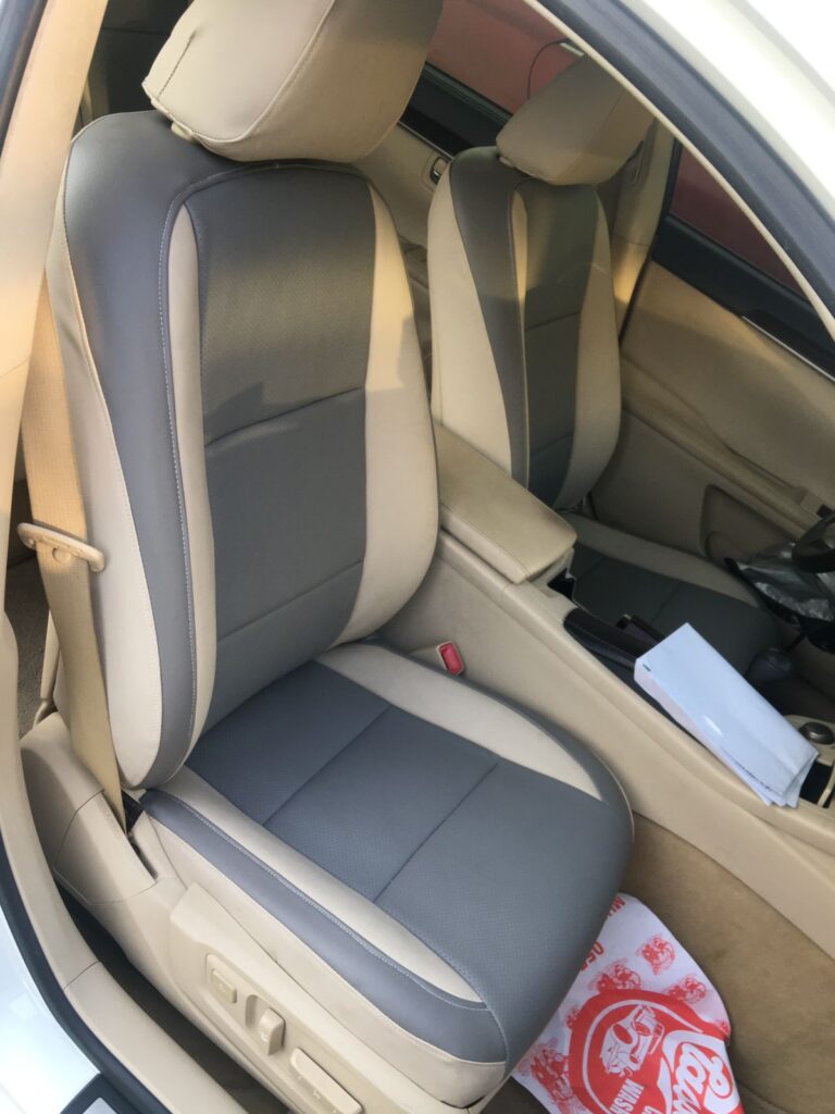 Interior view of a car featuring two seats with stylish upholstery, showcasing a modern and comfortable design.