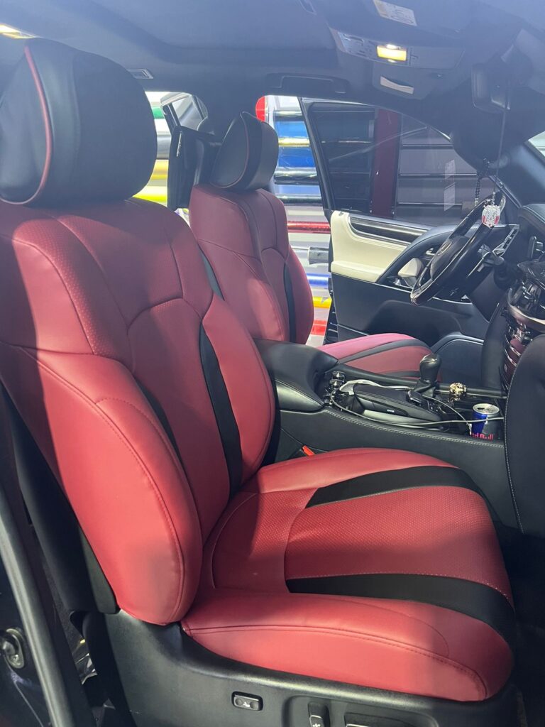 Interior view of a car featuring luxurious red leather seats, showcasing elegant car seat upholstery design.