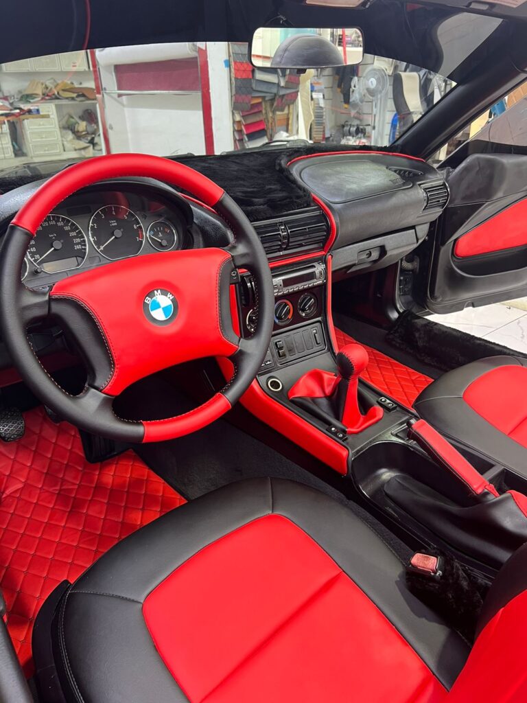 BMW Z4's interior highlights rich red leather upholstery, merging luxury and comfort in a modern sports car design.