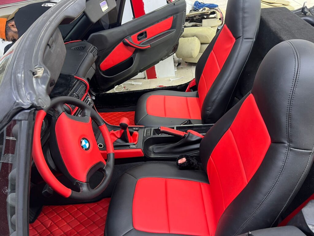 Interior of a BMW Z4 adorned with vibrant red leather upholstery, exemplifying sophistication and style in car interiors.