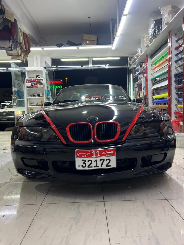 A BMW Z3 with a 2.0 engine and 6-speed manual transmission, featuring a vibrant car wrap design.