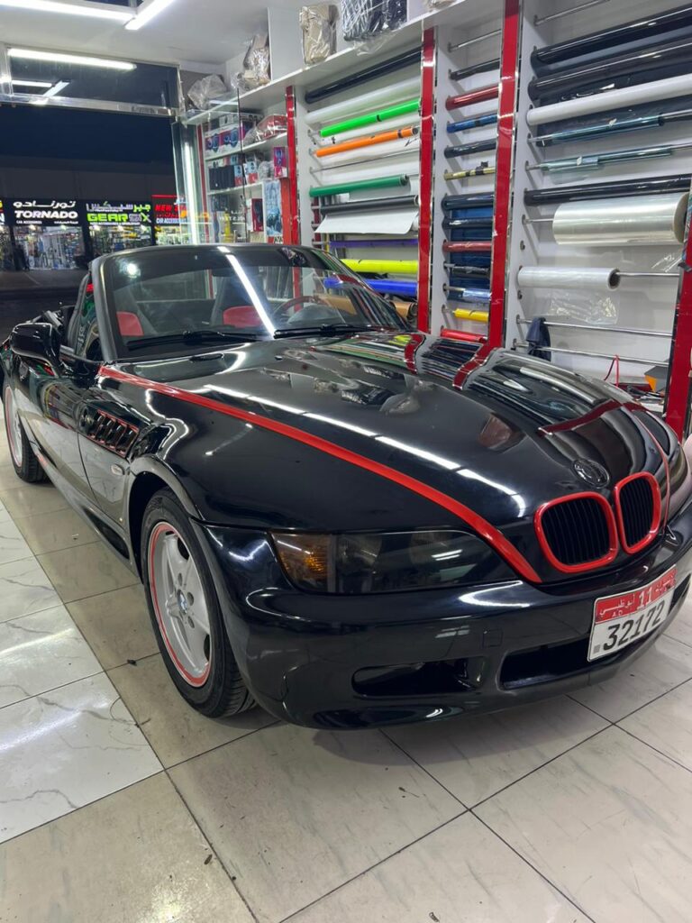 A stylish BMW Z8 convertible, adorned with an eye-catching car wrap, showcasing its elegant lines and sporty character, is on display at AlBadiya in Abu Dhabi.