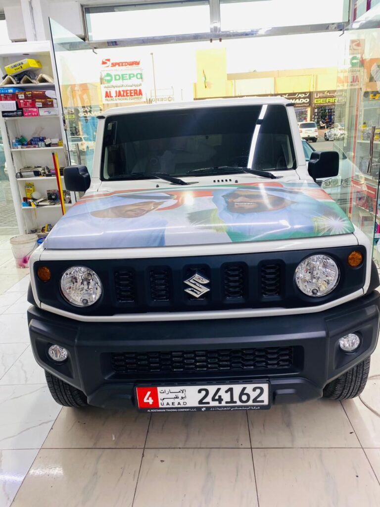 A Suzuki Jimny with a striking car wrap at AlBadiya shop in Abu Dhabi