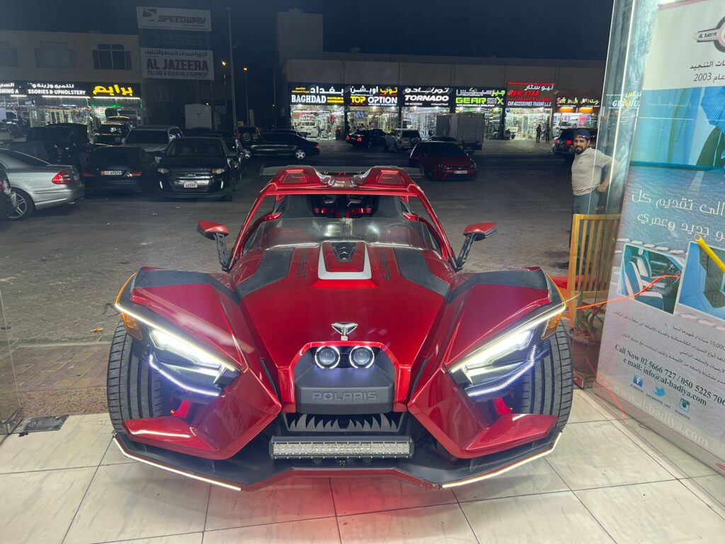 A stunning red sports car with a unique wrap was elegantly parked in front of AlBadiya, enhancing the store's vibrant atmosphere.