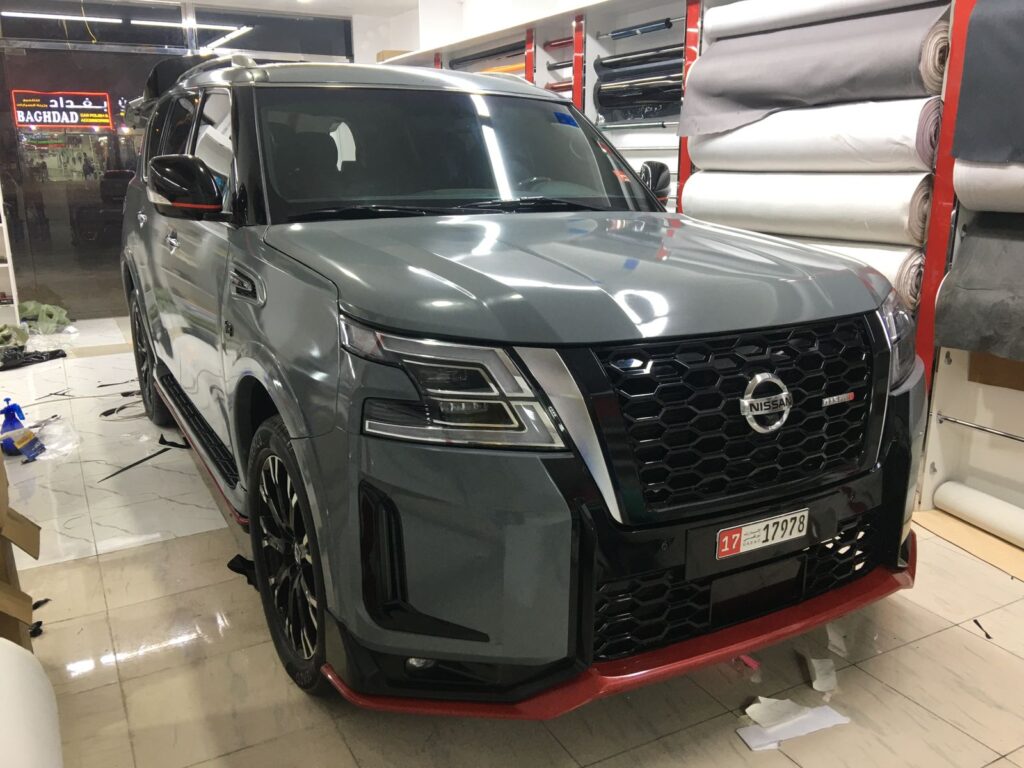 Eye-catching Nissan Armada XL with a custom 2-door body kit, showcasing a dynamic car wrap and stylish tinted windows.