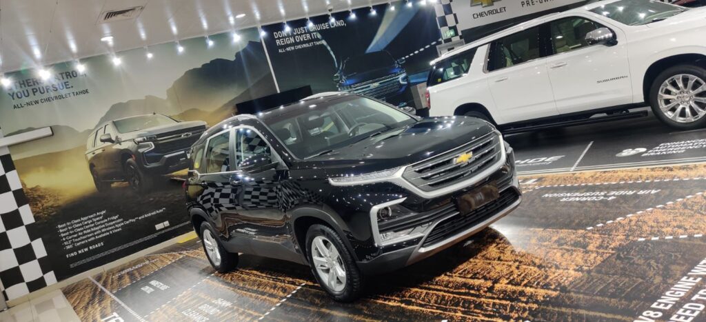 A Chevrolet SUV showcased in a showroom, featuring custom car wrapping and sleek window tinting for enhanced aesthetics.