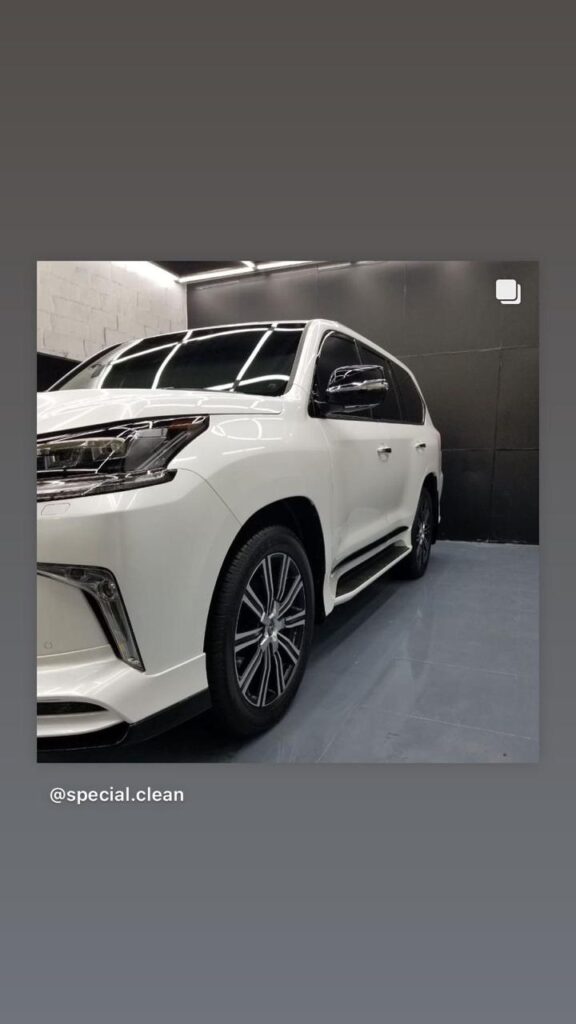 A new Toyota Highlander SUV displayed, featuring a sleek car wrap and tinted windows for enhanced style and privacy.