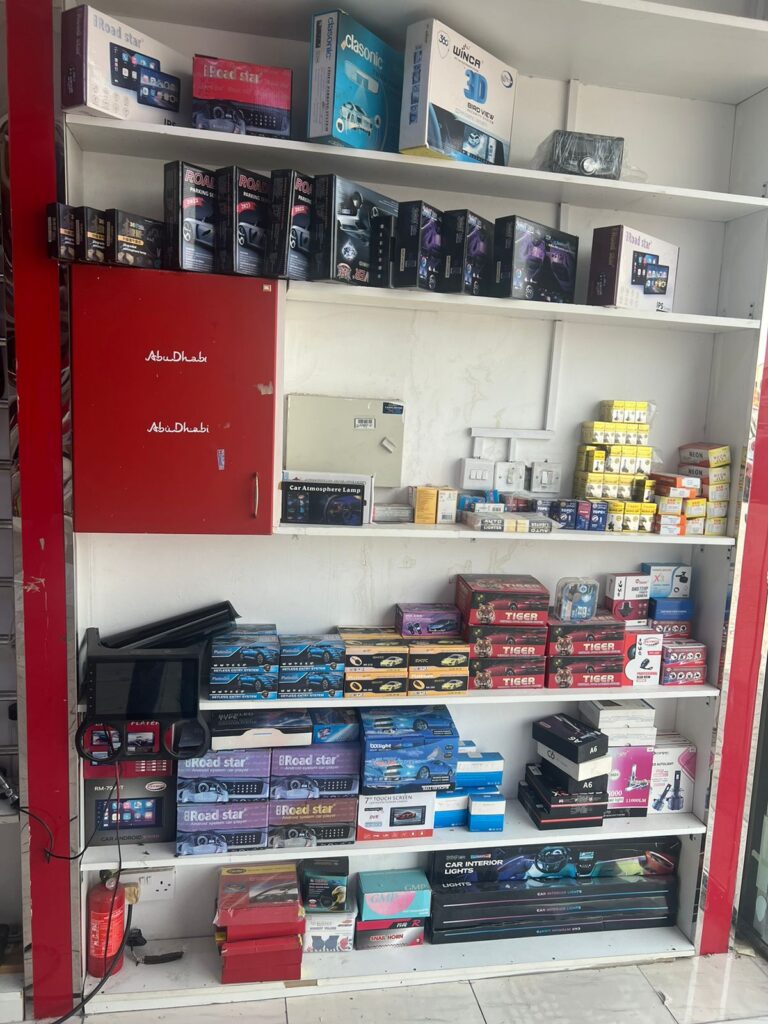 High-quality car accessories are kept on the shelf with the label "Abu Dhabi" displayed twice.